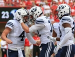 BYU quarterback Tanner Mangum congratulates Mitch Matthews(4) for his heroic catch in perfect storybook ending form. 